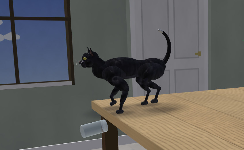 A simulated black cat on a table, pushing a glass over the edge